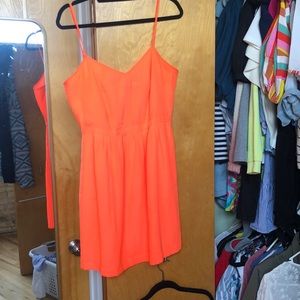 Neon orange silky skinny strap dress.